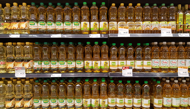 Various brands of canola oils on shelves